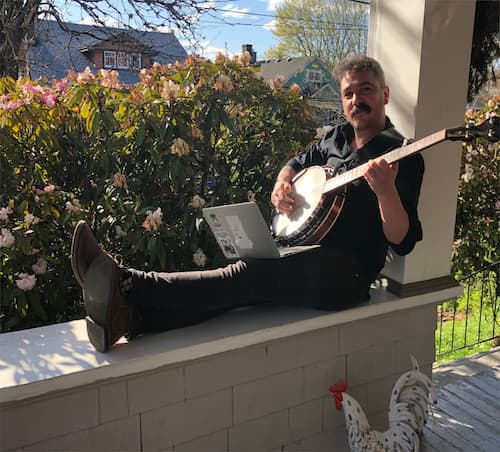 Max on porch coding and playing banjo